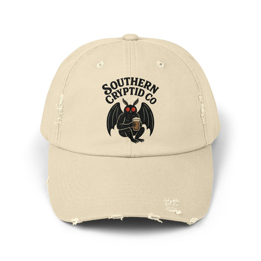 Distressed dad hat with Southern Cryptid Co. logo featuring Mothman holding a pint of beer.